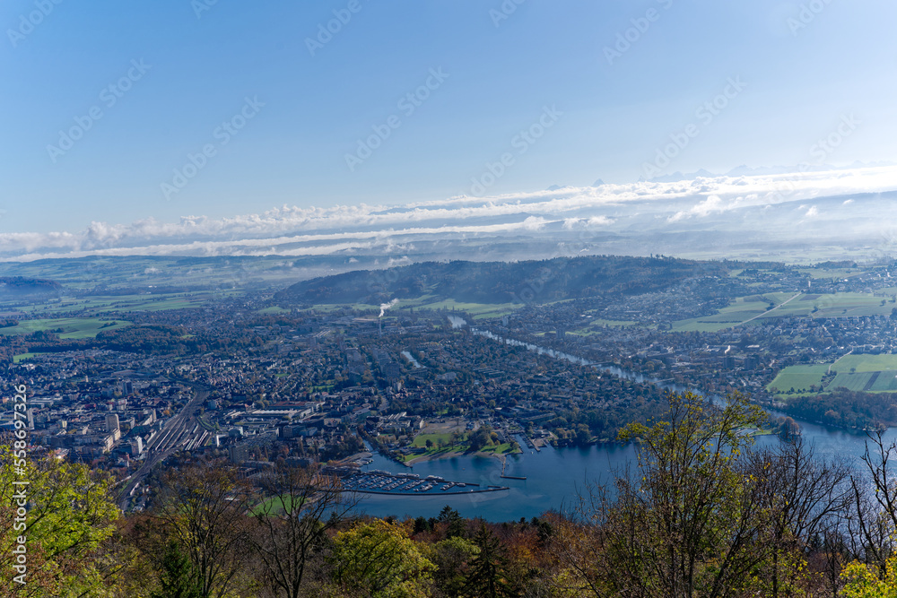 Aerial view from village Magglingen Macolin, Canton Bern, over City of Biel Bienne and lake with Aaare River on a blue cloudy autumn day. Photo taken November 10th, 2022, Magglingen, Switzerland.