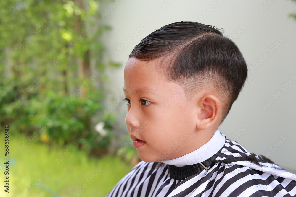 Portrait of Asian boy cut in haircut in the garden, fashion haircut for a guy. Portrait of Asian boy cut in haircut in the garden, fashion haircut for a guy.