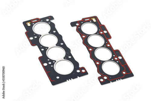 Two cylinder head gaskets with red sealant on a white background. View on two sides. A small shadow.