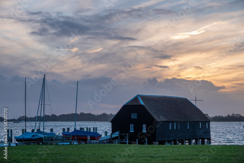 Raptackle wooden hut in Bosham West Sussex England with the sun going down in the background