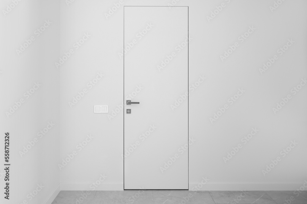 White flush doors on a white wall White flush doors on a white wall