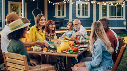 Group of Multiethnic Diverse People Having Fun, Communicating with Each Other and Eating Vegetarian Meals at an Outdoors Dinner. Relatives and Friends Gathered Outside Their Home on Warm Summer Day.