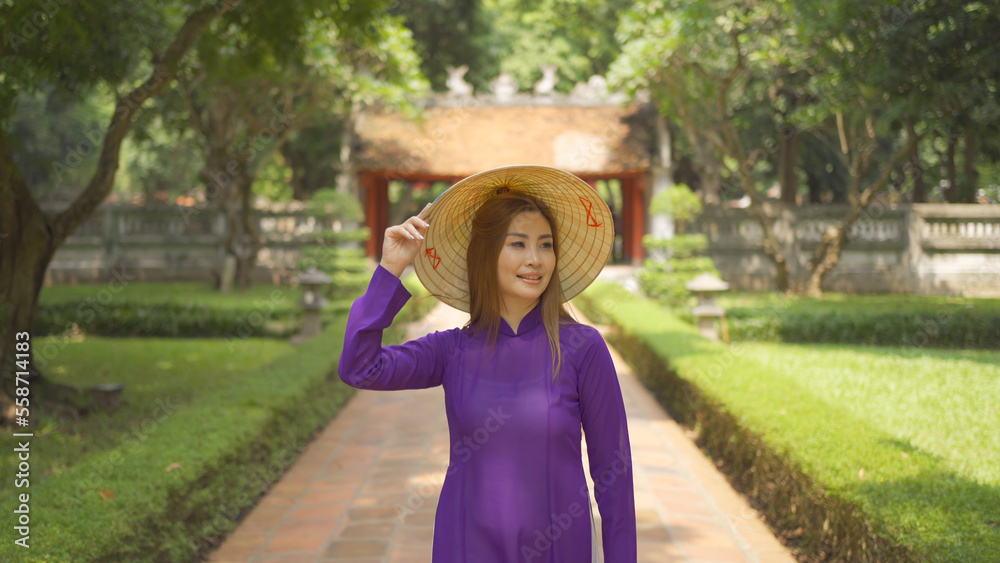 Portrait of Asian Vietnamese woman girl in local temple traveling in Hanoi urban city town, Vietnam. People lifestyle.