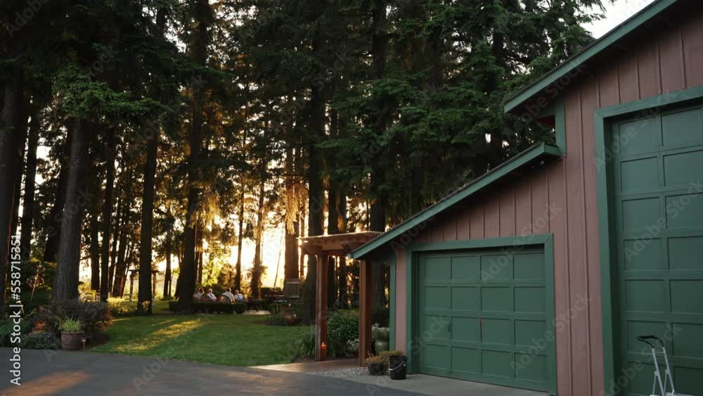 American house in the countryside on sunset, cozy corner beside forest, green garden. Real estate property, family house with garage.