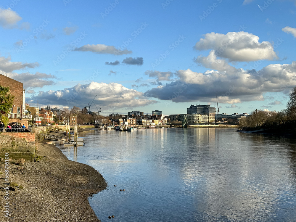 London, UK. Hammersmith riverside.Upper Mall street view. Thames river.Low tide, sunny winter day.Walking path along the Thames river.Leading to Hammersmith Bridge.Popular walking route