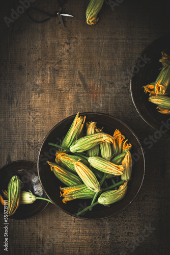 Zucchini flowers againsta wooden rustic background photo