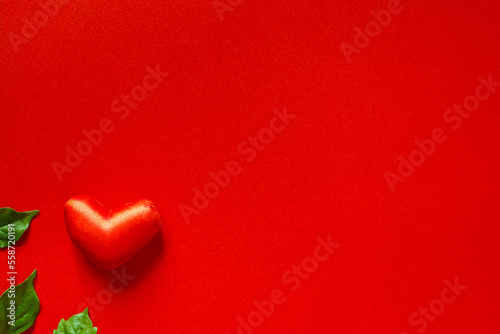 Valentine s day banner with one red heart on a red background with space for text. Love and happiness.