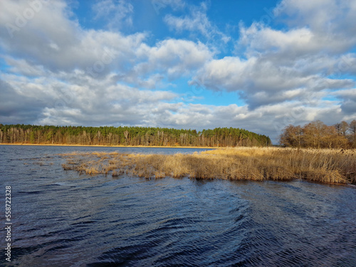 lake in winter with beautiful clouds in the blue sky © Svitlana