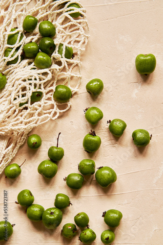Kiwi Berries on Beige Background with Cloth Bag photo