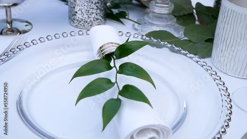 Plate with napkin decorated with a branch Wedding Table Decoration with Bouquets of Natural Fresh Flowers for a Family Feast