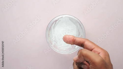 hand hold a jar of hair gel, photo