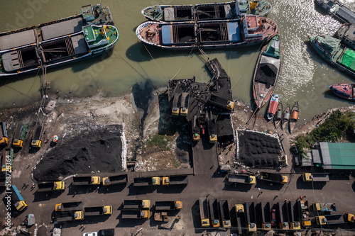 Aerial view of boats along the riverbank unloading coal, Bhairab Upazila, Kishoreganj, Bangladesh. photo