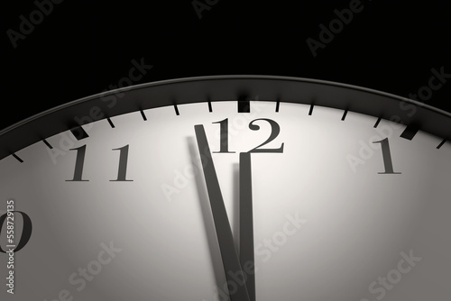 Round black and white clock with both the hour arm and minute arm almost pointing to 12 o'clock. Illustration of the concept of due date, deadline, countdown and doomsday