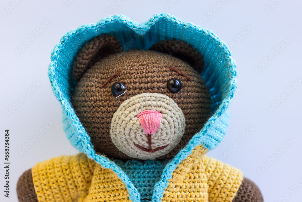 Knitted bear in a blue-yellow suit. Mishka is a patriot of Ukraine. Knitted bear in a blue-yellow suit. Mishka is a patriot of Ukraine.