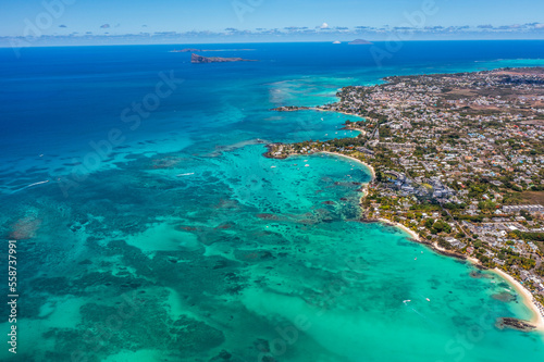 Grand Baie, Mauritius - aerial landscape view of Grand Bay, the infrastructure and buildings along the coastline, many boats on water and Gunner's Quoin in background 