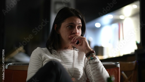 Candid woman in conversation at night, casual real life