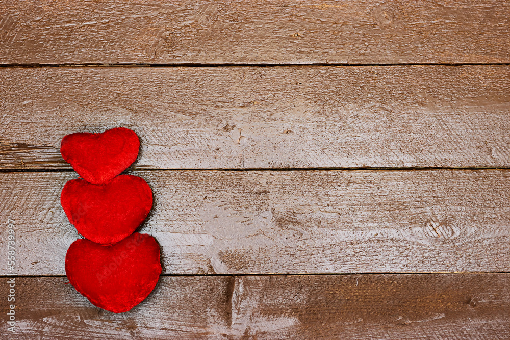 Fototapeta premium three heart isolated on wooden table