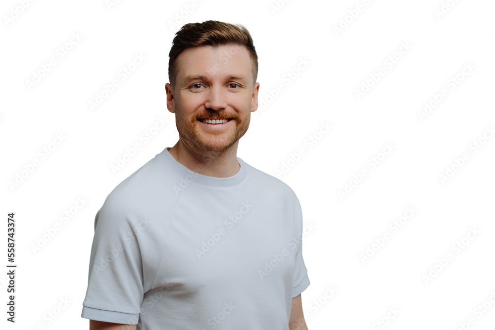 Young positive unshaven guy in white shirt has happy facial expression while looking at camera, handsome hairy man posing against blue studio background. Positive emotions concept Young positive unshaven guy in white shirt has happy facial expression while looking at camera, handsome hairy man posing against blue studio background. Positive emotions concept