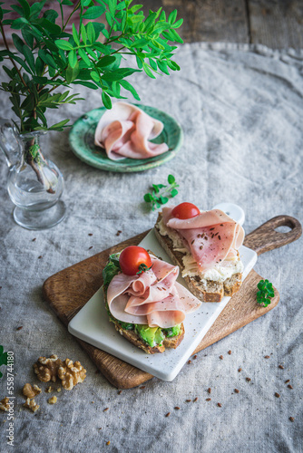 Avocado and ham on toast with tomato photo