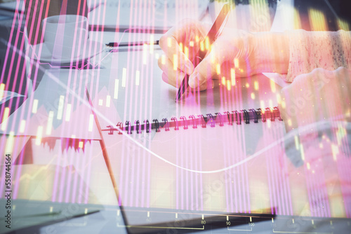Wallpaper Mural Hand taking notes in notepad. Forex chart holograms in front. Concept of research. Double exposure Torontodigital.ca