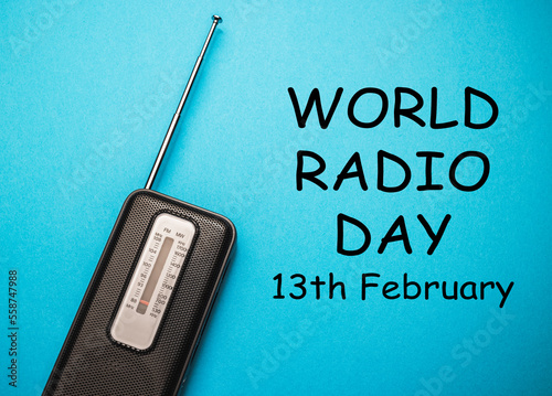 World Radio Day 13 February text with radio on blue background. Selective focus photo