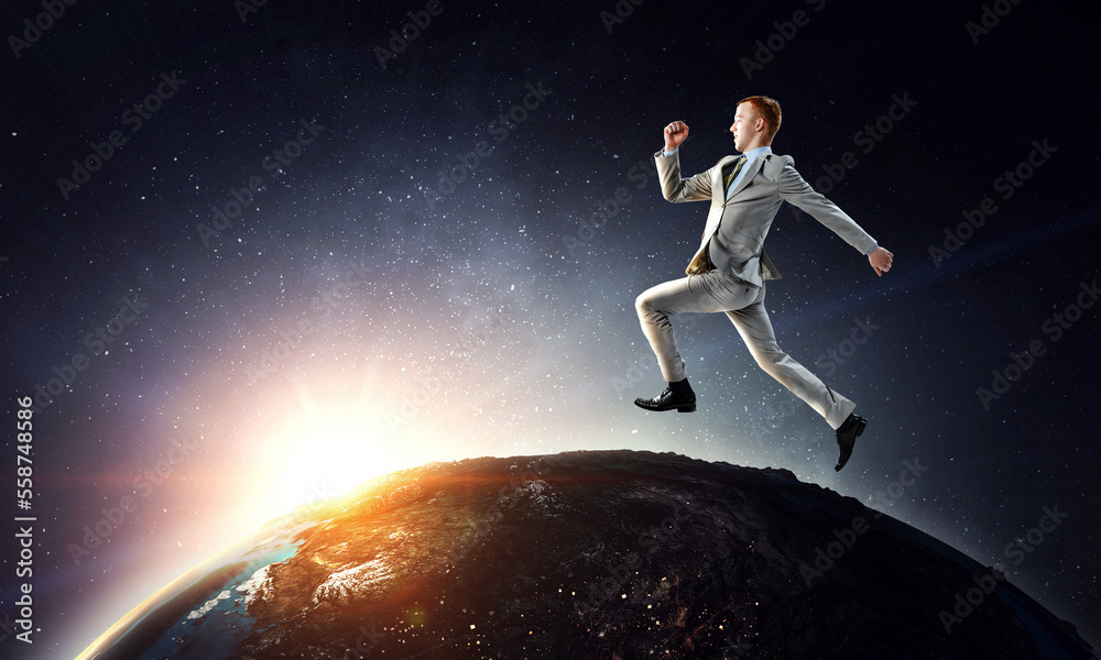 Portrait of energetic businessman jumping in open air