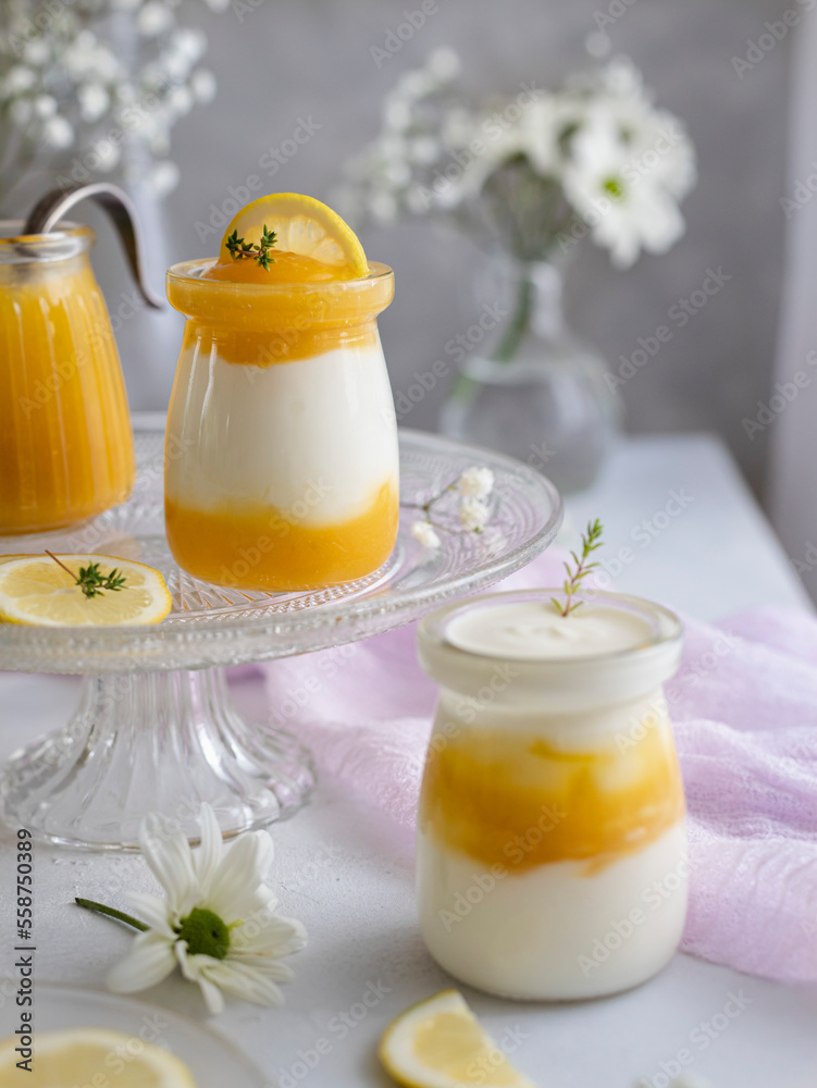 Lemon curd and greek yogurt with thyme in glass jars. Soft romantic scene. Lemon curd and greek yogurt with thyme in glass jars. Soft romantic scene.