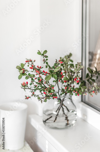 Branches of quince with little rose flowers in a vase