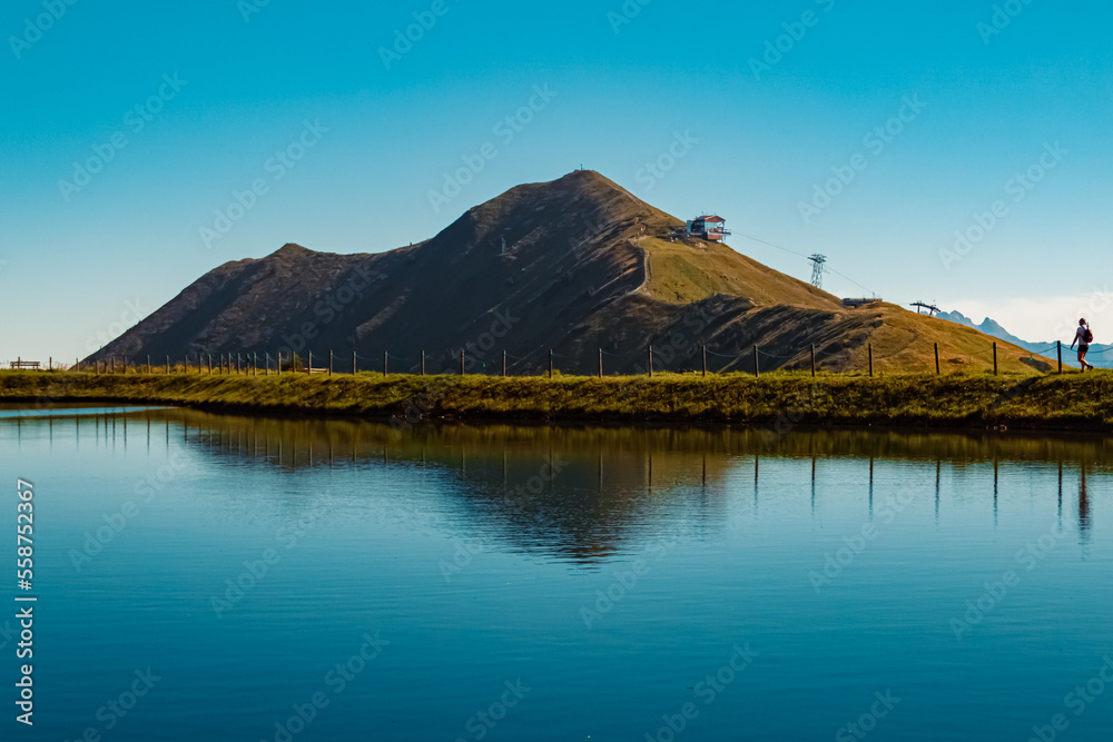 Beautiful alpine summer view with reflections in a lake at the famous Kanzelwand summit, Riezlern, Vorarlberg, Austria Beautiful alpine summer view with reflections in a lake at the famous Kanzelwand summit, Riezlern, Vorarlberg, Austria