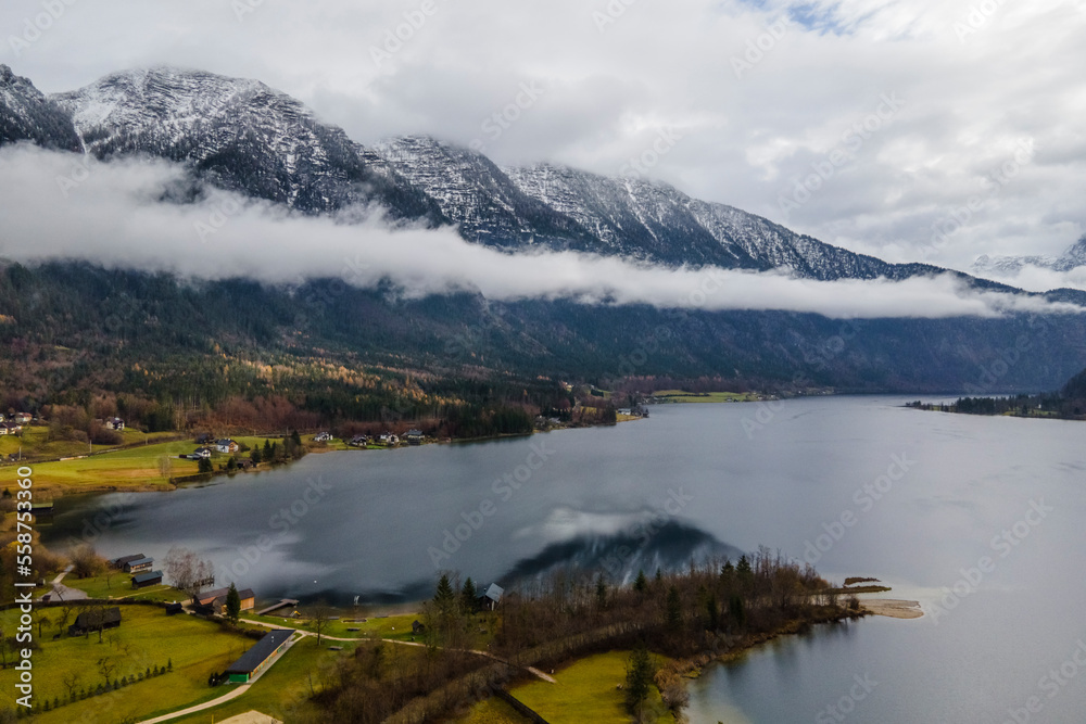 Aerial view of a small village along the lakefront with mountain, Hallstatter See lake, Upper Austria, Austria.