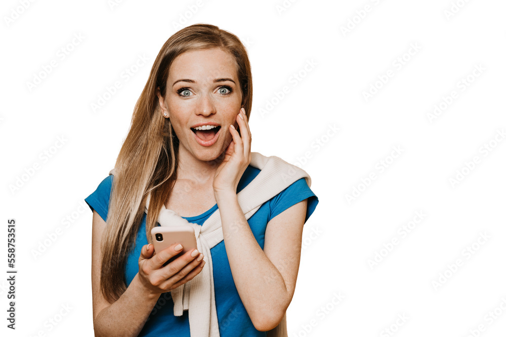 Excited redhead cheerful girl dressed in casual, looks shocked with wide open mouth and eyes after video call with boyfriend, got superb news. Stands over transparent background. Happy people concept. Excited redhead cheerful girl dressed in casual, looks shocked with wide open mouth and eyes after video call with boyfriend, got superb news. Stands over transparent background. Happy people concept.