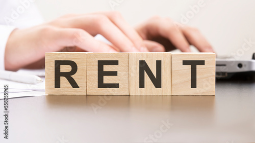 man made word Rent with wood blocks on the background of the office table. selective focus. business concept.