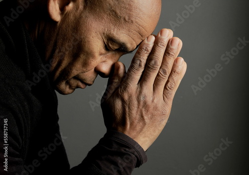 people praying to god at home on black background with people stock photo