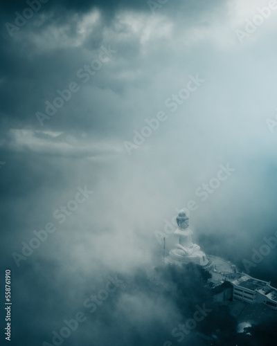 Aerial view of Big Buddha statue on hill in Phuket, Thailand covered with fog. photo