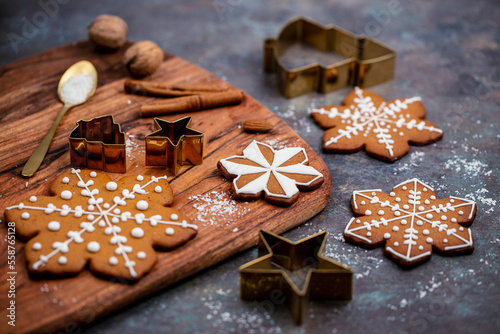Christmas gingerbread cookies and spices on wooden table