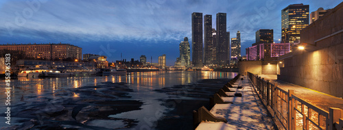 Panorama of frozen Moskva river and Moscow business center skyscrapers at nightfall