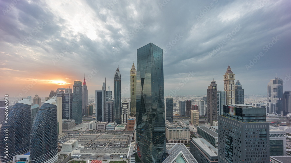 Panorama of futuristic skyscrapers with sunset in financial district business center in Dubai on Sheikh Zayed road timelapse