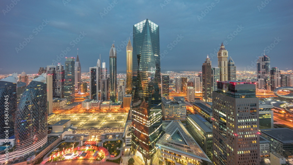 Fototapeta premium Panorama of futuristic skyscrapers in financial district business center in Dubai night to day timelapse