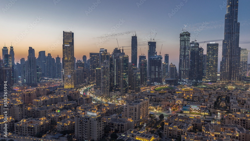 Obraz premium Dubai's business bay towers aerial day to night timelapse. Rooftop view of some skyscrapers