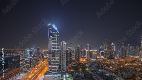 Panorama showing Dubai s business bay towers aerial night timelapse. Rooftop view of some skyscrapers