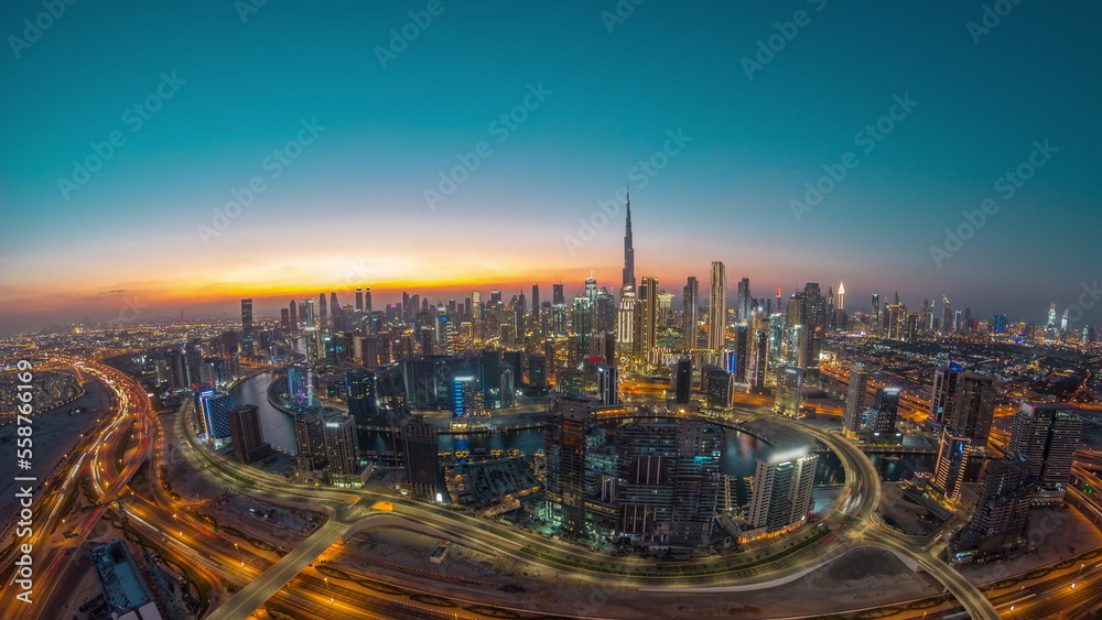 Panoramic skyline of Dubai with business bay and downtown district day to night timelapse.