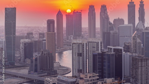 Skyline with modern architecture of Dubai business bay towers at sunset timelapse. Aerial view © neiezhmakov