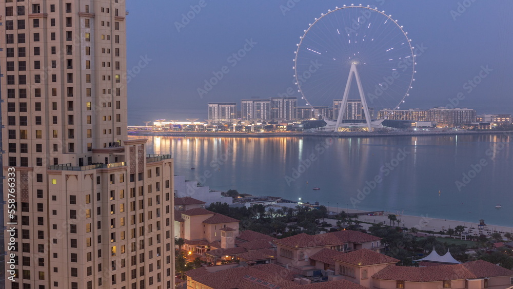 Bluewaters island with modern architecture and ferris wheel aerial night to day timelapse.