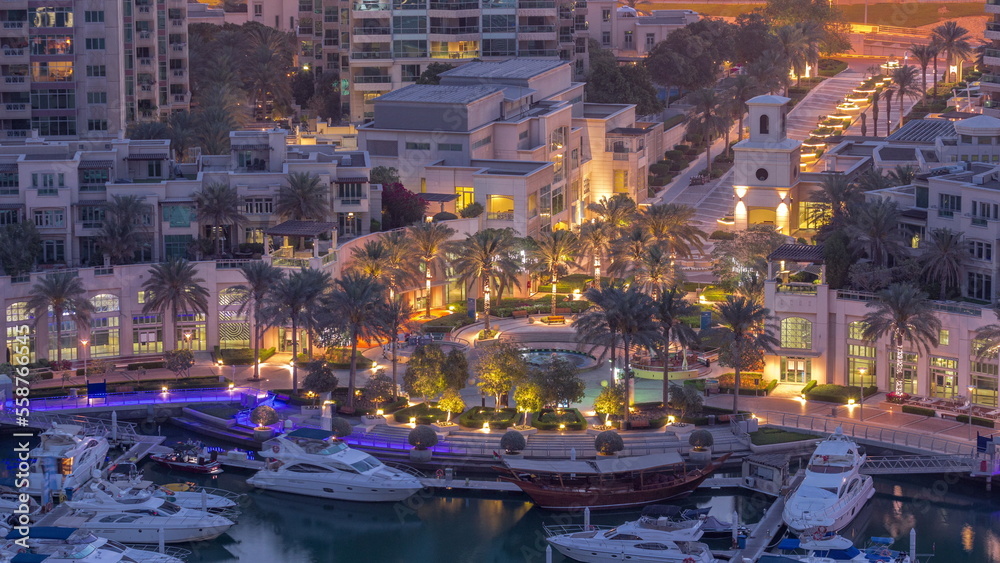 Picturesque fountain on Dubai Marina promenade aerial night to day timelapse