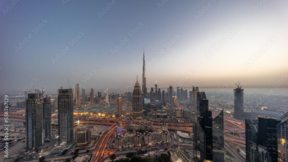 Aerial panorama view of tallest towers in Dubai Downtown skyline and highway day to night timelapse.