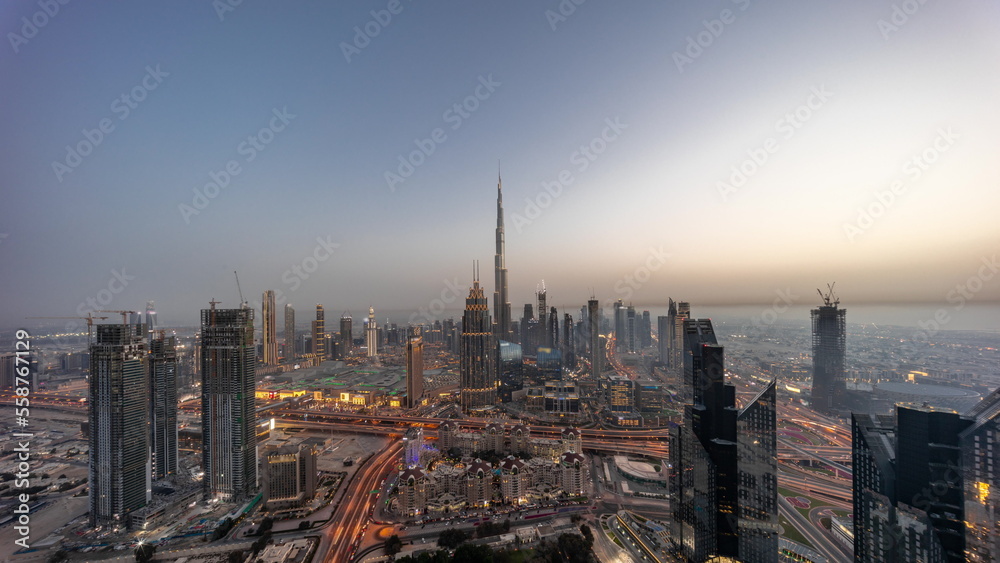 Obraz premium Aerial panorama view of tallest towers in Dubai Downtown skyline and highway day to night timelapse.
