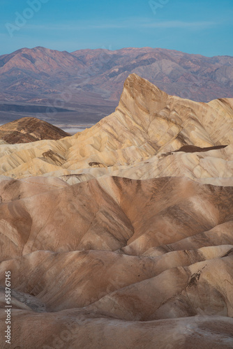 Glowing Rocks at Zabriskie Point with Mountains in the Background During Sunrise, Death Valley National Park, California