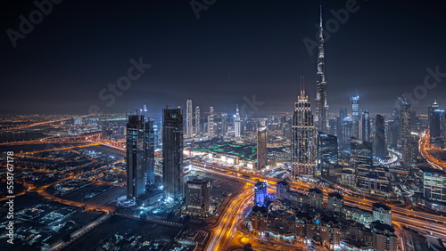 Photography Panorama showing aerial view of tallest towers in Dubai Downtown skyline and highway night timelapse