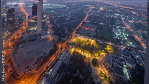 Villas in Zabeel district with skyscrapers on a background aerial night to day timelapse in Dubai, UAE