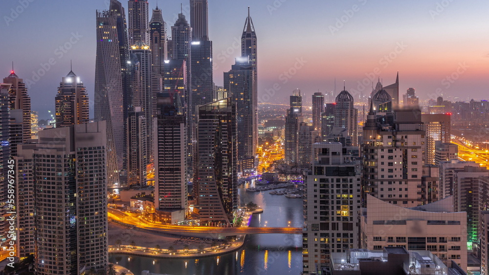 Obraz premium View of various skyscrapers in tallest recidential block in Dubai Marina aerial night to day timelapse